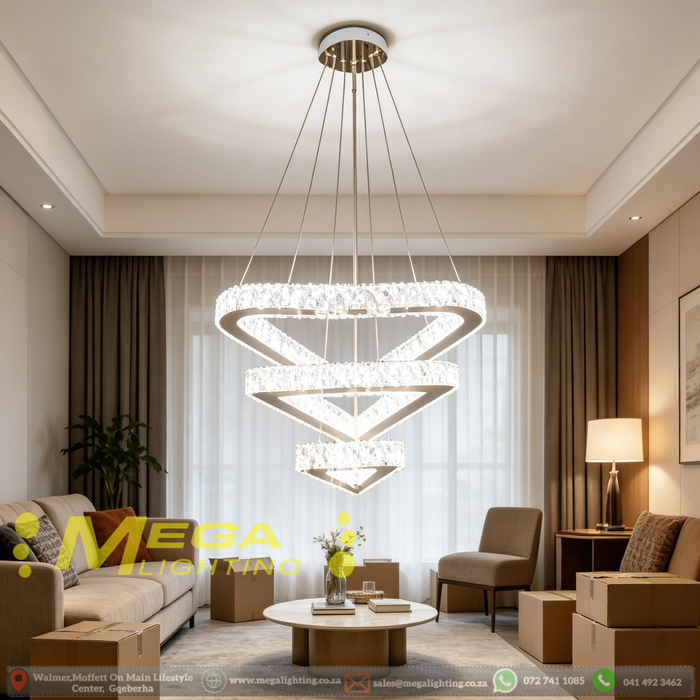 3-tier silver crystal triangle LED chandelier suspended above a modern dining table, emitting warm white light – Mega Lighting