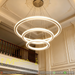 3-tier LED ring chandelier with nested 40cm, 60cm, and 80cm rings, adjustable height 1-2 meters, installed in a modern high-ceiling living room.