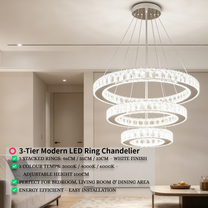 3-tier white circular LED ring chandelier suspended above a modern bed, emitting warm white light – Mega Lighting