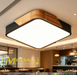 40x40cm square wood-frame ceiling light with natural wood grain and 4000K neutral white glow, installed in a modern living room.