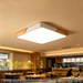 40x40cm square wood-frame ceiling light with natural wood grain and 4000K neutral white glow, installed in a modern living room.