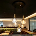 5-light globe cluster pendant light with Ø40cm round black base, 15cm clear bubble glass globes and brass lamp holders, adjustable height decorative hanging lamp for dining room cafe living room, MEGA LIGHTING South Africa