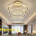 5-ring white LED pendant chandelier with cascading 30-60cm rings, warm glow above a modern dining table.