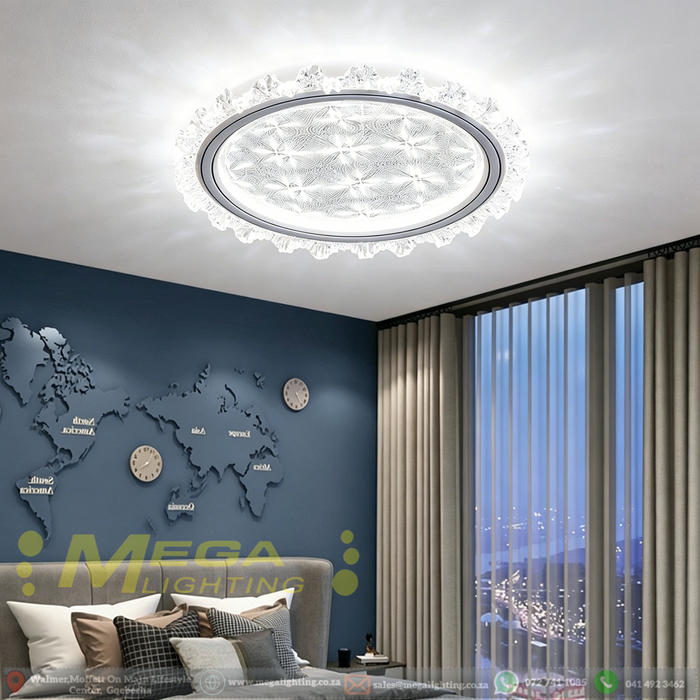 50cm LED crystal flush ceiling light with starburst pattern diffuser and petal-shaped crystal trim, installed in a modern bedroom with warm lighting.

