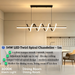 54W LED twirl spiral linear chandelier with twisted spiral light strip, 1m length, warm glow above a modern dining table.