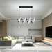 54W LED twirl spiral linear chandelier with twisted spiral light strip, 1m length, warm glow above a modern dining table.