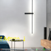 Modern geometric cross LED wall sconce with multi-directional glow, mounted in a hallway – Mega Lighting