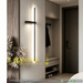 Modern geometric cross LED wall sconce with multi-directional glow, mounted in a hallway – Mega Lighting