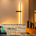 Modern geometric cross LED wall sconce with multi-directional glow, mounted in a hallway – Mega Lighting