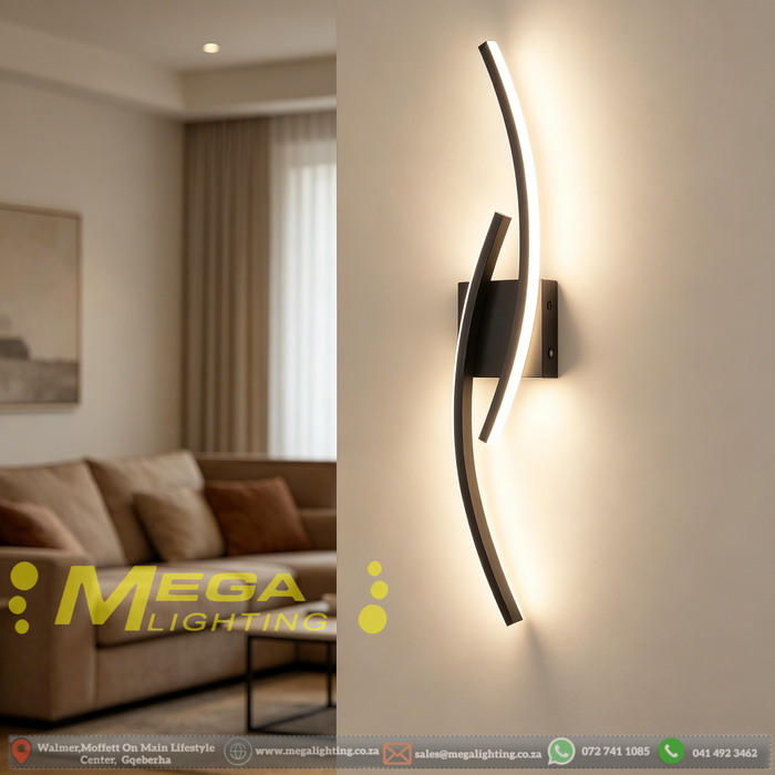 Modern 60cm black curved LED wall light installed on a staircase wall, emitting warm white light – Mega Lighting