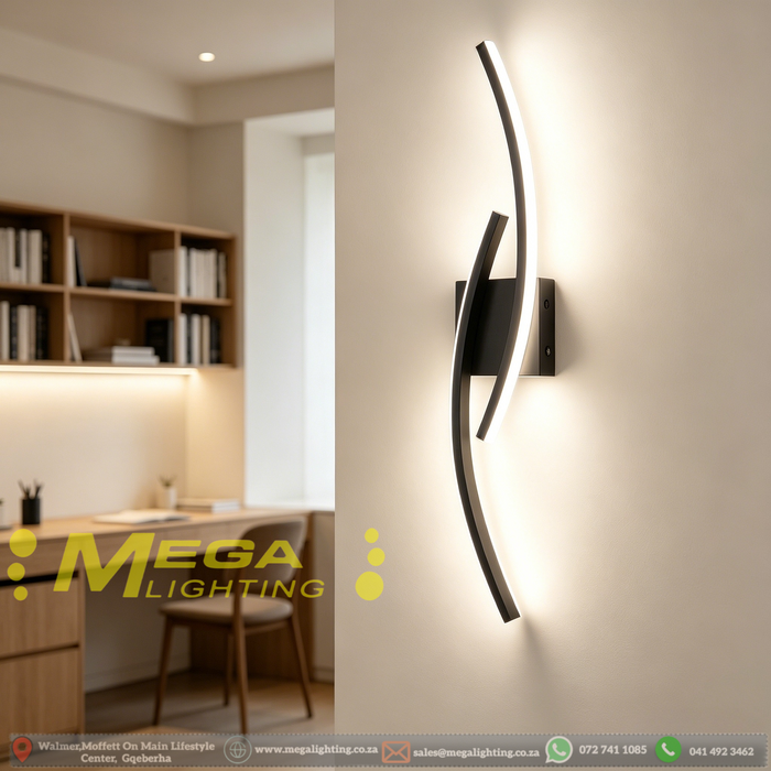 Modern 60cm black curved LED wall light installed on a staircase wall, emitting warm white light – Mega Lighting
