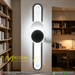 60cm matte black geometric circular-oval LED wall light installed in a modern hallway, emitting warm white light – Mega Lighting