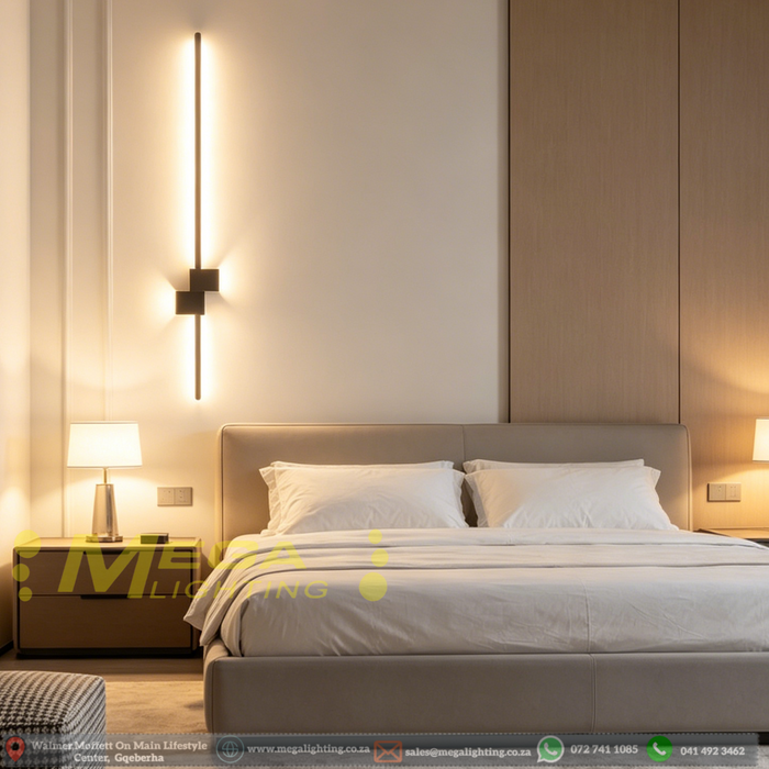 60cm matte black linear LED wall light installed on a living room wall, emitting warm white light – Mega Lighting