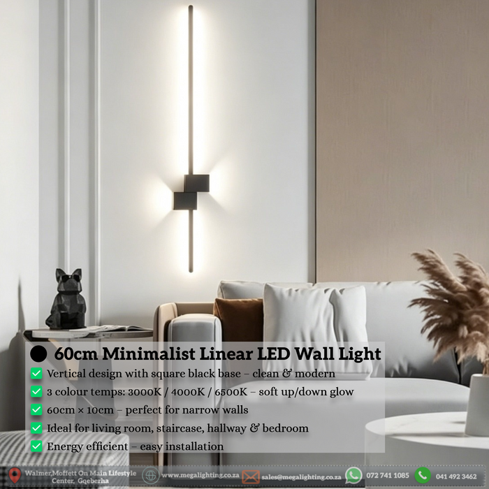 60cm matte black linear LED wall light installed on a living room wall, emitting warm white light – Mega Lighting