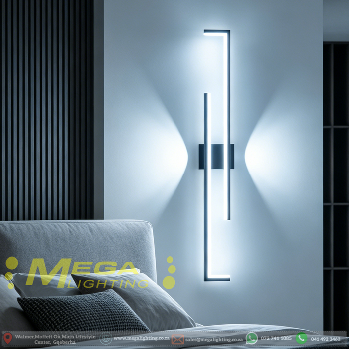 Modern 60cm black linear LED wall light installed on a bedroom wall, emitting warm white light – Mega Lighting