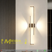 Modern 60cm black linear LED wall light installed on a bedroom wall, emitting warm white light – Mega Lighting