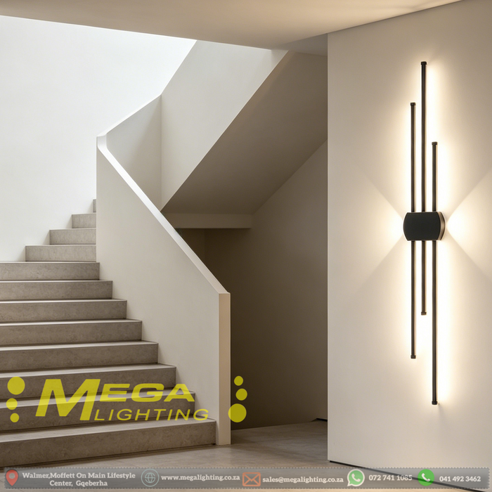Modern staggered vertical LED wall sconce with three rods, mounted beside a sofa – Mega Lighting