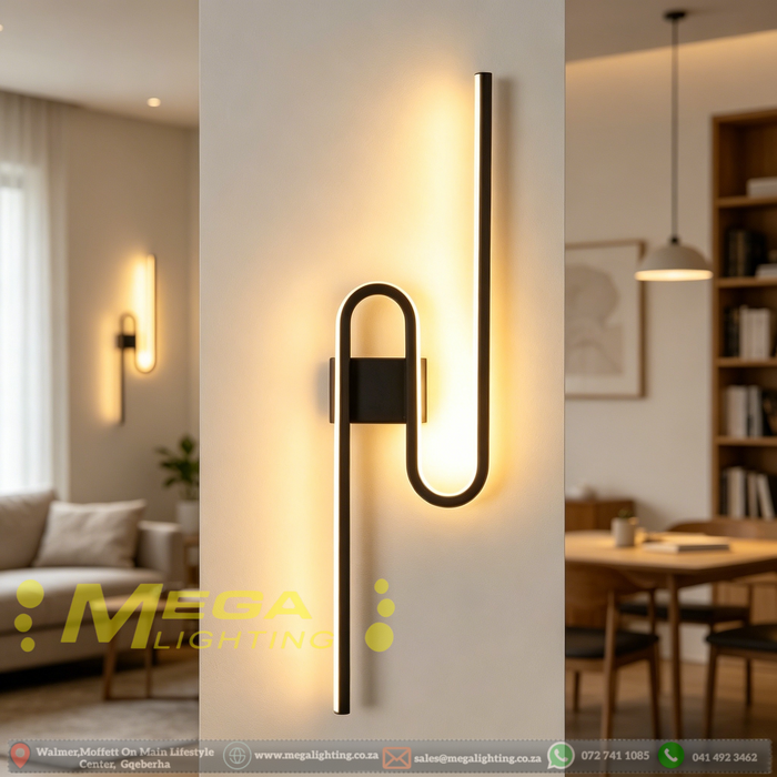 61cm matte black U-shaped looped LED wall light installed in a modern living room, emitting warm white light – Mega Lighting