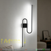 61cm matte black U-shaped looped LED wall light installed in a modern living room, emitting warm white light – Mega Lighting