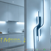 63cm matte black twisted dual-wavy LED wall light installed in a modern bedroom, emitting warm white light – Mega Lighting