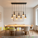 7-light smoke gradient glass pendant light with matte black frame, linear design, warm glow above a dining table