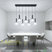 7-light smoke gradient glass pendant light with matte black frame, linear design, warm glow above a dining table