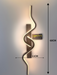 60cm matte black zig-zag wave LED wall light installed in a modern living room, emitting warm white light – Mega Lighting