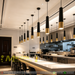 Black and gold cylinder pendant light with adjustable height and GU10 LED bulb, modern dining room lighting.