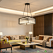 Black square 4-light chandelier with matte black finish, geometric design, installed above a modern dining table.