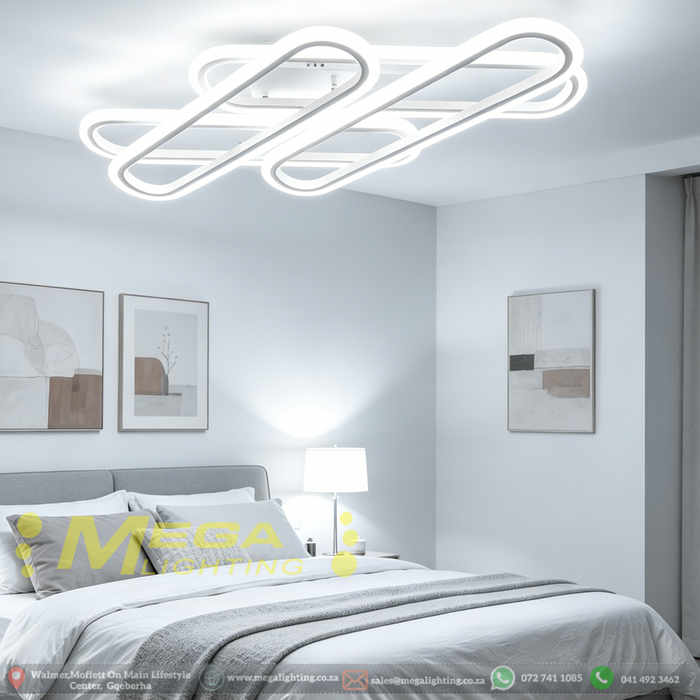 Interlocking design LED flush mount ceiling light in white finish, 52x13cm, warm glow in a modern living room.


