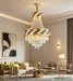 Luxury gold crystal chandelier with polished brass frame and faceted crystal strands, installed in a modern dining room, warm sparkling light.