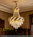 Luxury gold crystal chandelier with polished brass frame and faceted crystal strands, installed in a modern dining room, warm sparkling light.