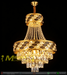 Luxury gold crystal chandelier with polished brass frame and faceted crystal strands, installed in a modern dining room, warm sparkling light.