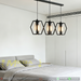 3-heads hexagon industrial pendant lamp with matte black frame and clear glass, 1m bar, suspended above kitchen island.