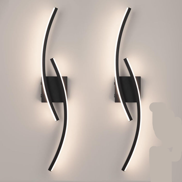 Modern 60cm black curved LED wall light installed on a staircase wall, emitting warm white light – Mega Lighting1