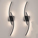 Modern 60cm black curved LED wall light installed on a staircase wall, emitting warm white light – Mega Lighting1
