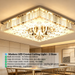 Modern LED crystal ceiling light with faceted crystal pendants and mirrored finish, installed in a contemporary living room, warm 3000K glow.
