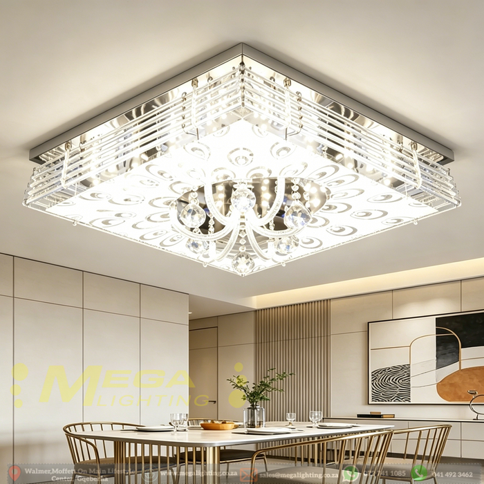 Modern LED crystal ceiling light with faceted crystal pendants and mirrored finish, installed in a contemporary living room, warm 3000K glow.