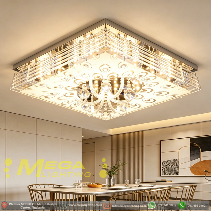 Modern LED crystal ceiling light with faceted crystal pendants and mirrored finish, installed in a contemporary living room, warm 3000K glow.