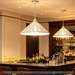 Black and white leaf cut-out pendant lights in modern South African dining room, adjustable 100cm height, 35cm diameter, 3000K/6500K light.