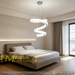 Modern white spiral LED chandelier suspended above a bed, emitting warm white light – Mega Lighting