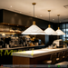 White perforated cone pendant light with brass accents, E27 bulb base, 100cm height, 35cm diameter, over modern bar and dining counter.
